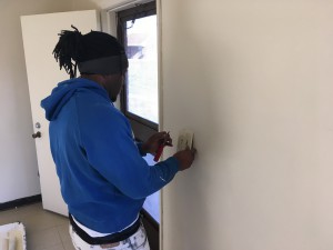 Immanuel Lofton, 23, puts an electric plate in place as part of getting a public housing unit ready to host a new family. The father of a young boy says he appreciates the second chance that the OIC of Wilson and the Wilson Housing Authority has given him and that the training he is getting will hopefully help him secure full-time employment when the program is over.